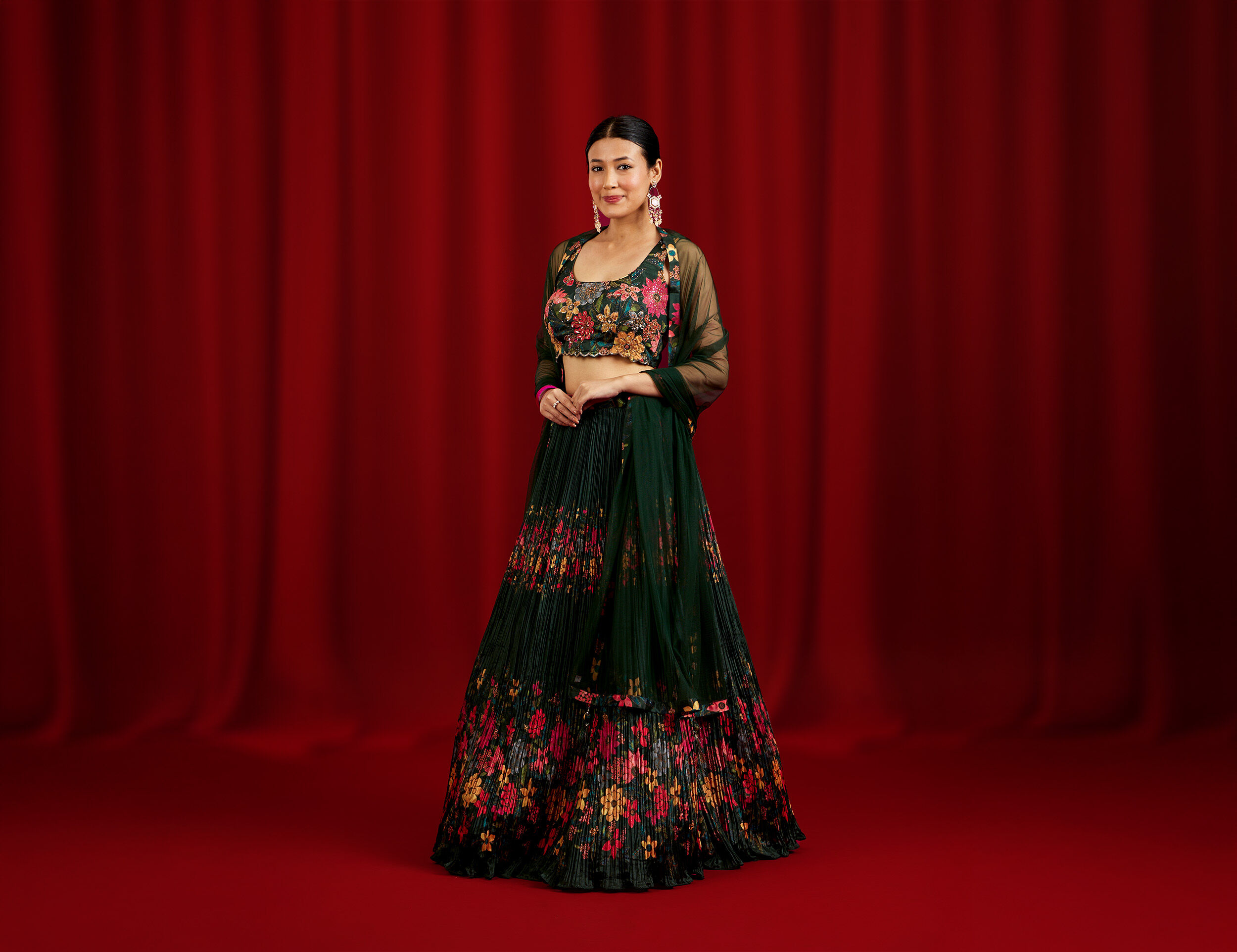 Stylish dark green lehenga featuring vibrant floral embroidery, perfect for a modern wedding look